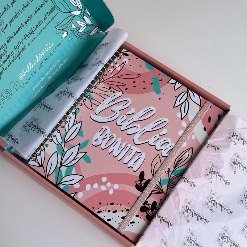 ** Estuche abierto mostrando una Biblia con diseño floral y el texto "Biblia Bonita" en la portada.