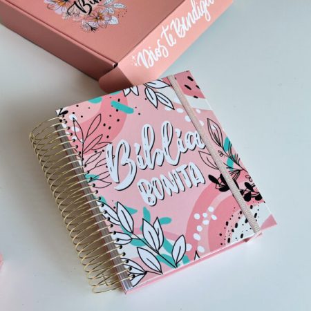 ** Biblia con cubierta decorativa en tonos rosados y motivos florales, con la inscripción "Biblia Bonita".