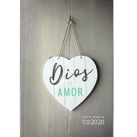 ** Portada de la Biblia con letrero en forma de corazón colgado que dice "Dios es Amor", sobre un fondo de madera gris.